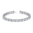Oval-cut diamonds set in an east-west platinum 4-prong bracelet.
