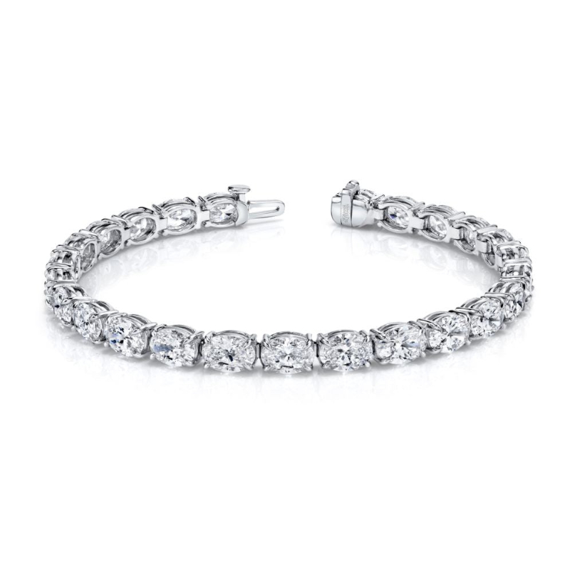 Oval-cut diamonds set in an east-west platinum 4-prong bracelet.